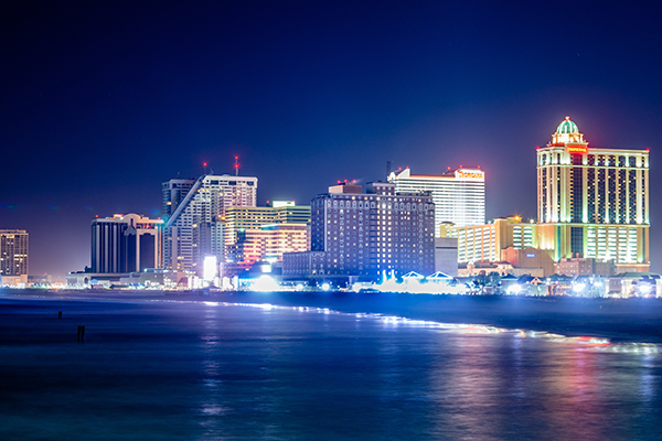 Skyline of Atlantic City, New Jersey at night at the boardwalk, one of the many casino junket destinations offered by Grand America Company, based in North Carolina