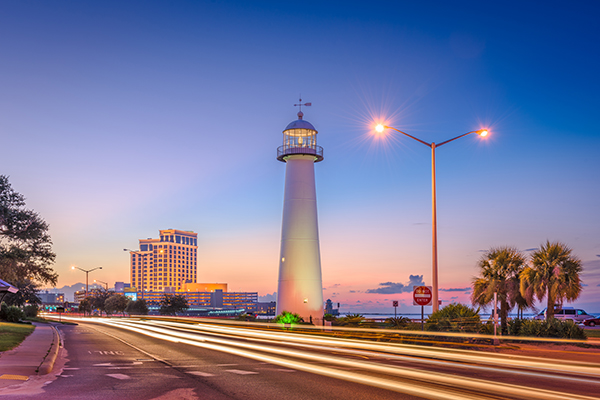 Biloxi, Missippi lighthouse and casino at night, one of the many casino junket destinations offered by Grand America Company, based in North Carolina