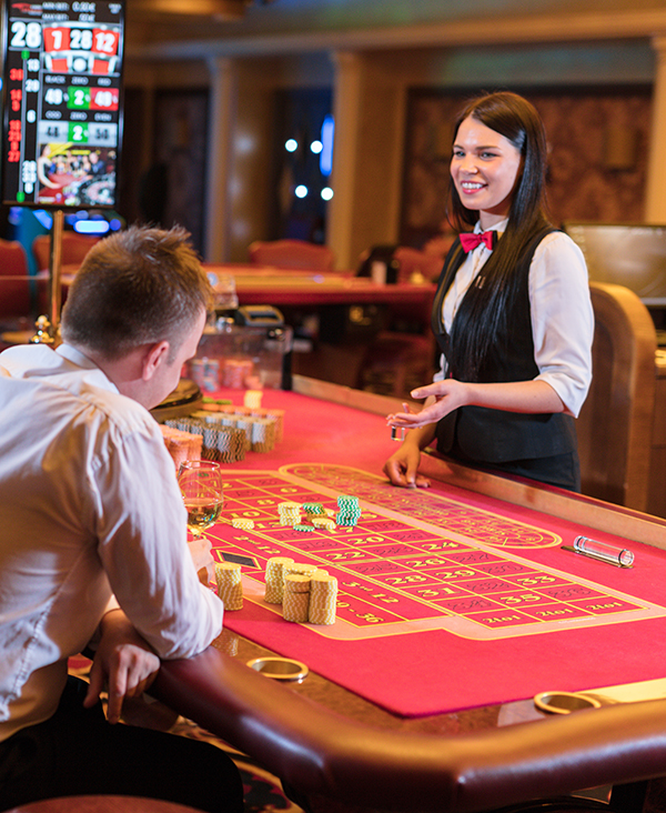 people playing at a casino table, one of the many gaming strategies supported by Grand America Company, a casino junket company based in North Carolina